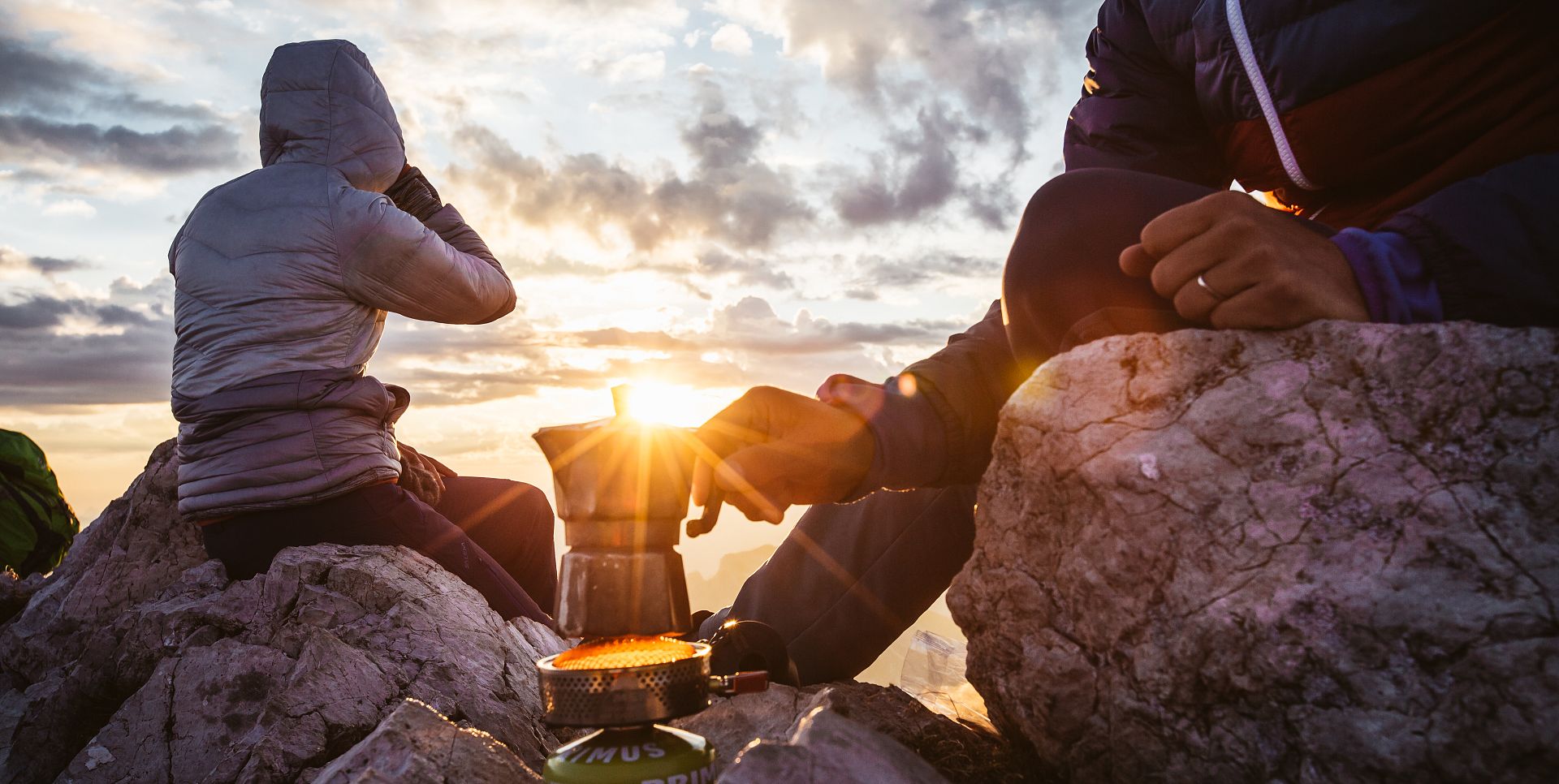 Two people at Widderstein prepare a coffee at sunrise.