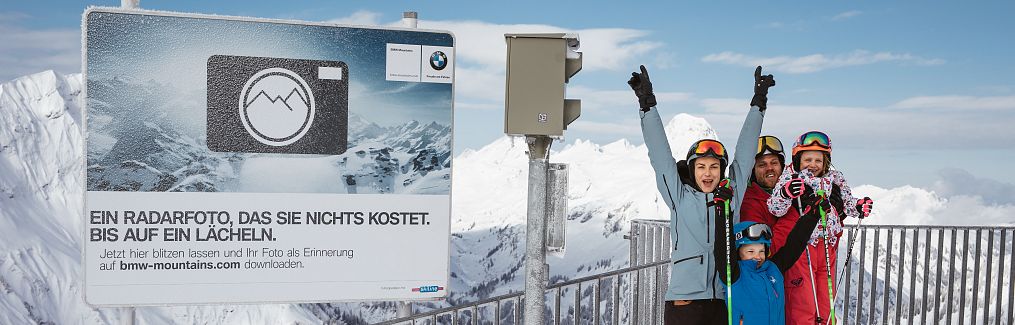 Eine Familie genießt den Fotopoint am Salober und den Blick auf die Winterlandschaft.
