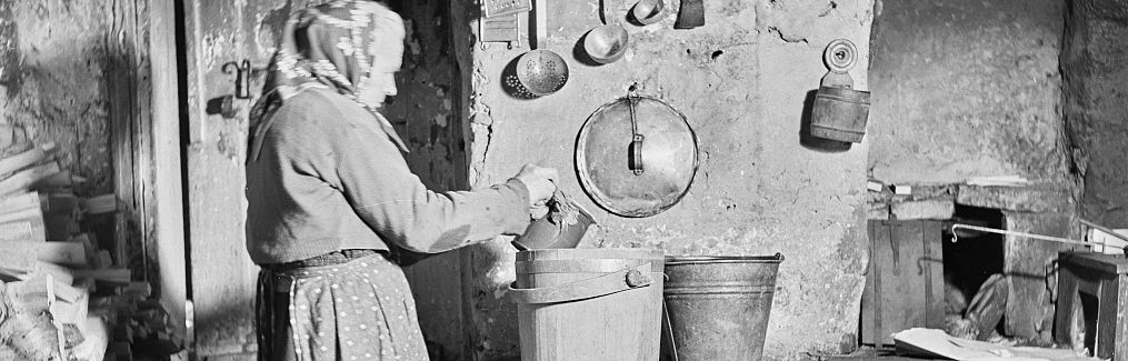 Old photo of a woman cooking.