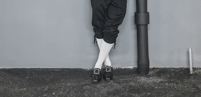 Close-up: Leather trousers and socks of a man in Walser costume.
