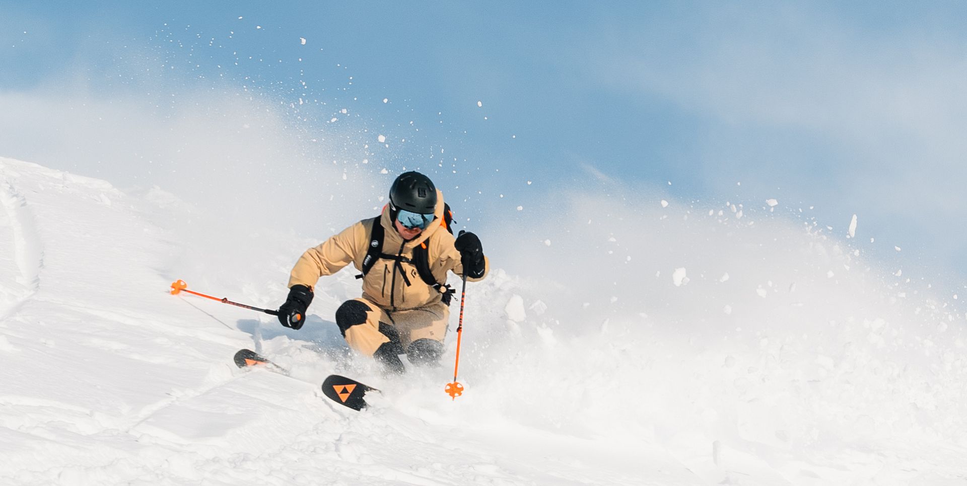 A man is skiing through deep powder snow.