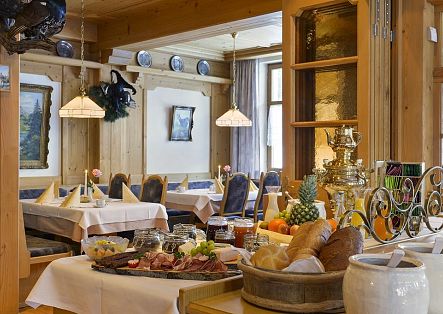 Ein reich gedecktes Buffet mit verschiedenen Platten in einem hellen Restaurantraum.