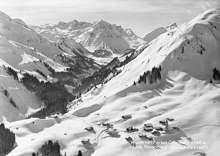 Historic photo of the village of Warth, completely covered in snow.