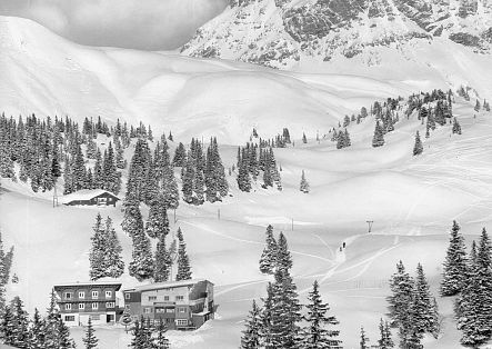 Historic image of the Körbersee Mountain Hotel, surrounded by snow.