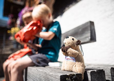 Two children open the gifts they received for completing their Murmele hiking pass.