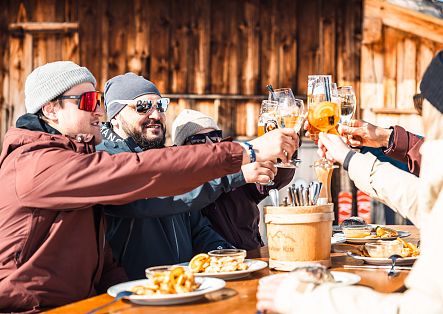 On the sun terrace, guests relax and toast with a cool drink.