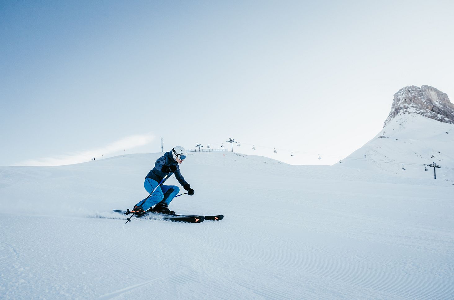 A woman skis down the perfectly groomed slopes into Auenfeld early in the morning.