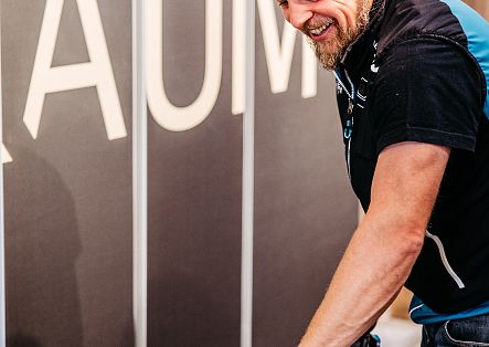 Ein Mitarbeiter bearbeitet einen Ski an einer Werkbank in der Sportgeschäft-Werkstatt.