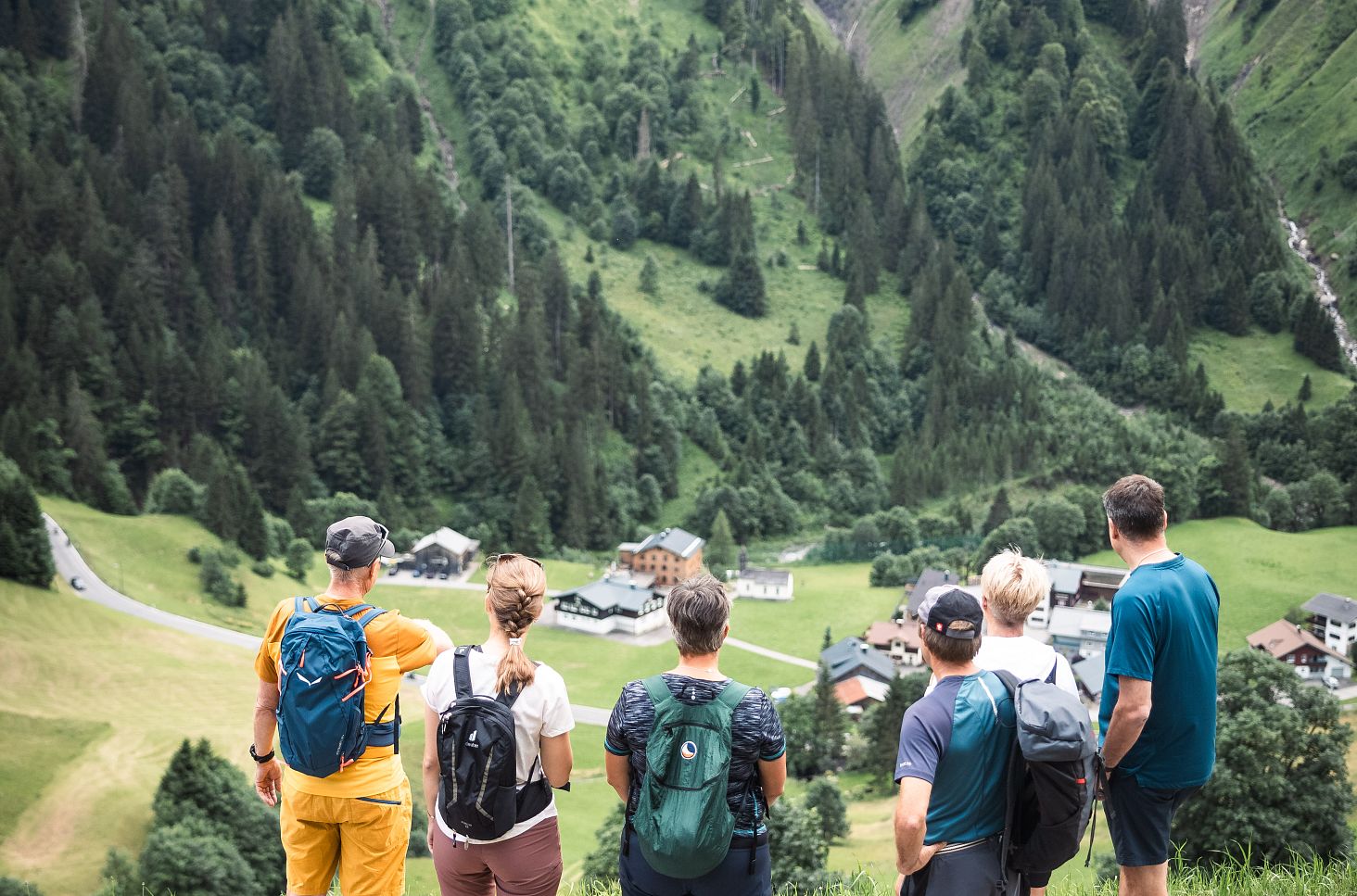 A hiking group enjoys the breathtaking view into the valley.